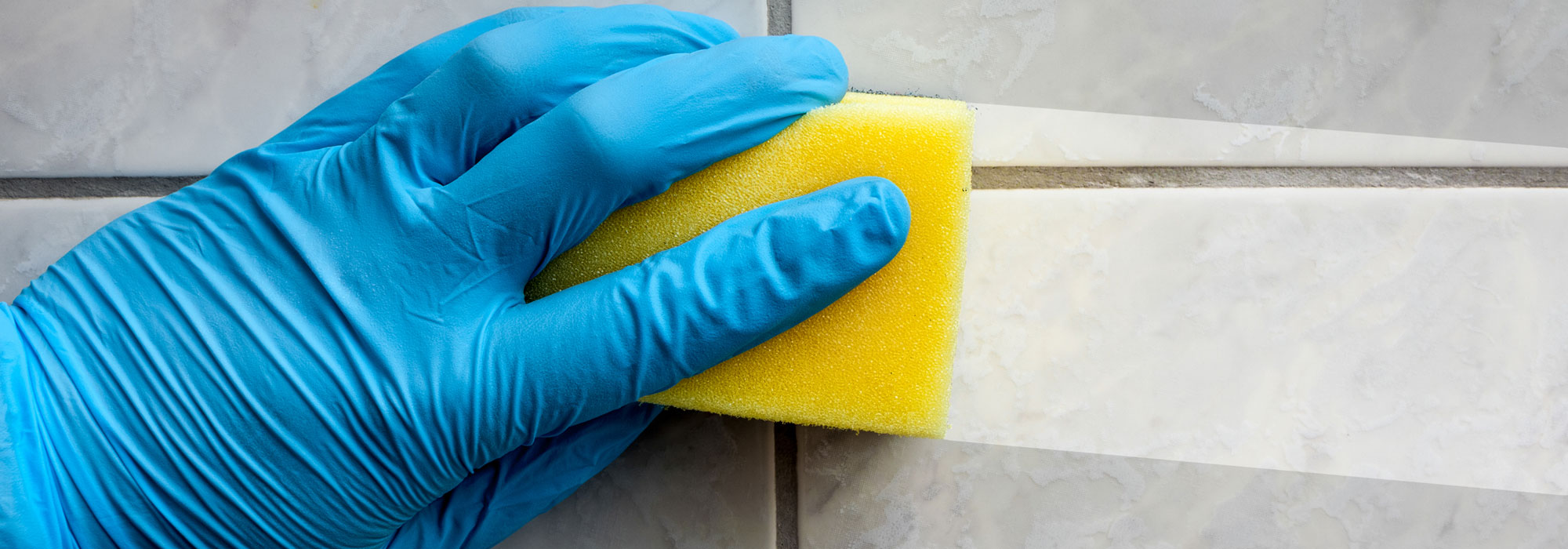 hand sponge wiping tile